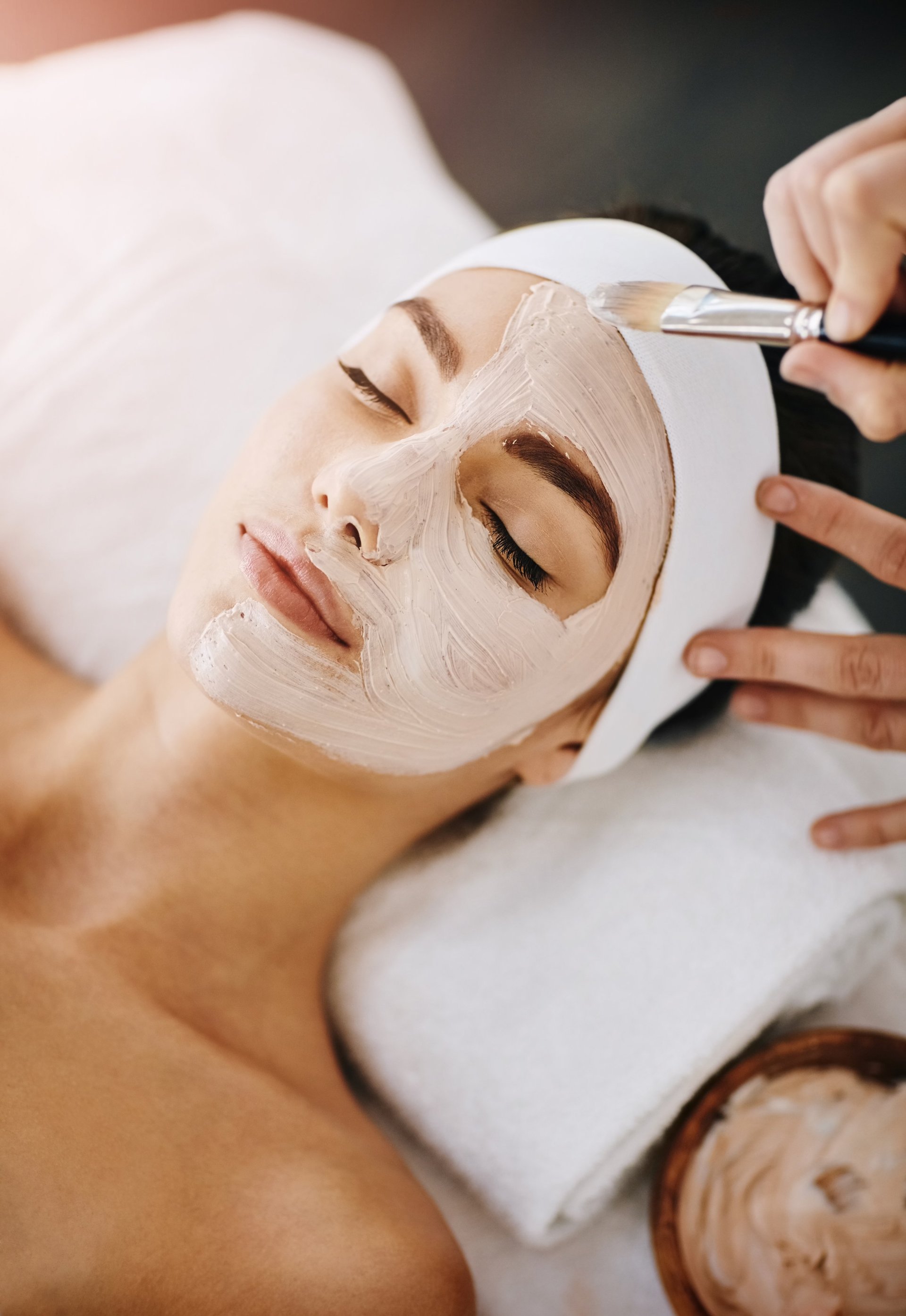 Attractive young woman getting a facial at a beauty spa, smooth and lift facial treatment