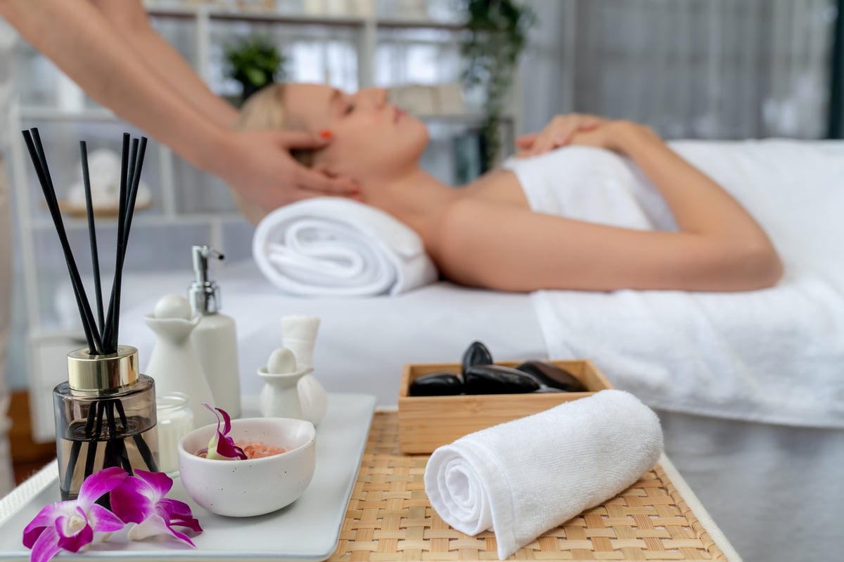 Aromatherapy massage ambiance with candles, essential oils, and spa elements creating a serene holistic training environment