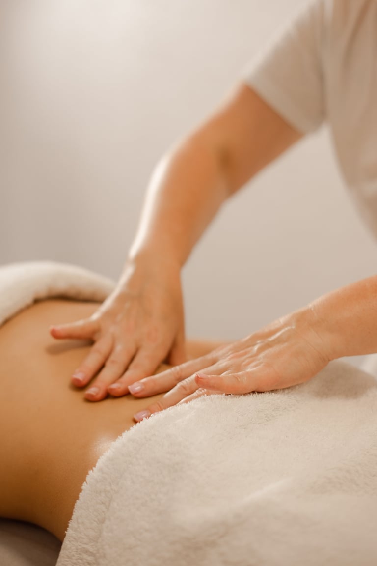 Professional Masseuse Performing Abdominal Massage