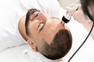 Professional facial treatment with microdermabrasion device